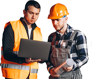 Two construction workers stand together. One, in an orange safety vest, holds a laptop. The other, wearing a hard hat and overalls, holds a rolled-up blueprint. They appear to be discussing plans with a clear view of the project site in front of them.